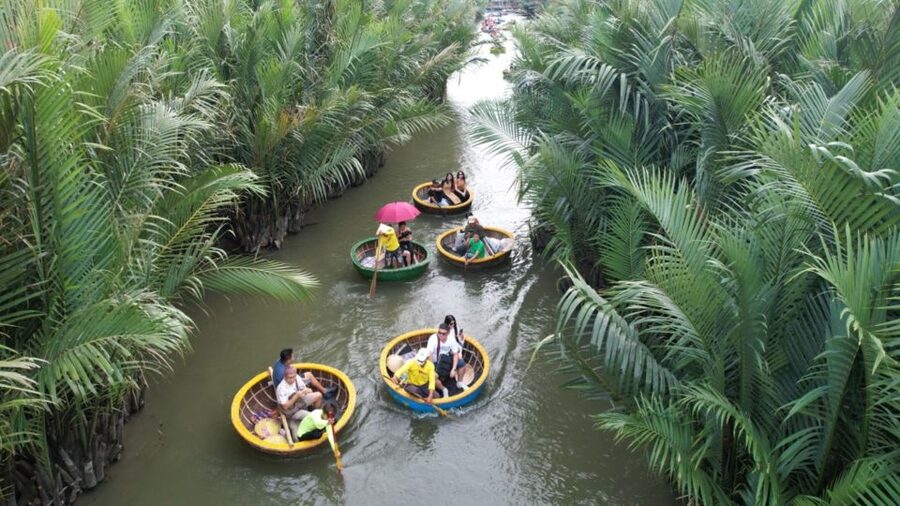 BUFFALO RIDING -BASKET BOAT & BIKE TOUR-HOI AN - Entering the nipa palm forest by basket boat