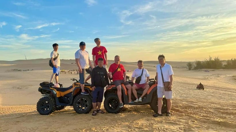 Mui Ne: Group Tour & Sunrise/Sunset Quad Bike Adventure - The coastal road and a brightly colored Jeep