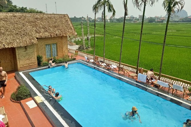 Ninh Binh Daily Tour: Hoa Lu -Mua Cave -Tam Coc- Bike-Swimming with Sunset Party - Tam Coc by sampan boat
