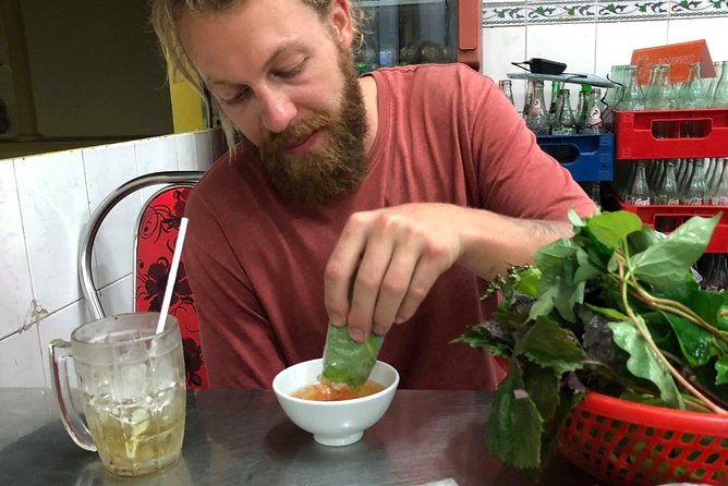 Saigon By Night and Street Food By Motorbike | Opt: Ao Dai Riders - Nguyen Trai Street, where the city keeps shopping