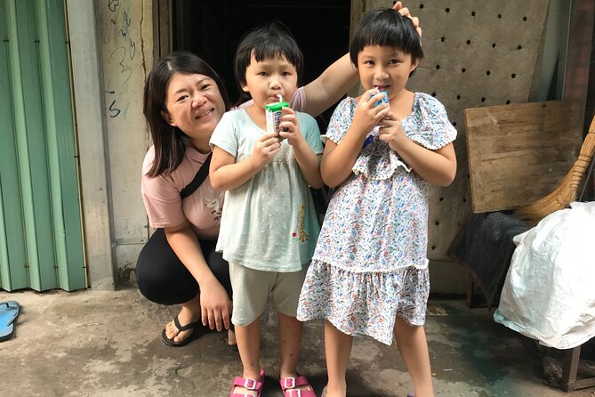 Saigon Slum tour and Saigon Chillspots by motorbike/ Aodai rider - Flowers, lotus shapes, and a local market stop