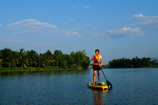 Stand Up Paddle Boarding and Sunset Watching on Cai River - Getting steady on the SUP board